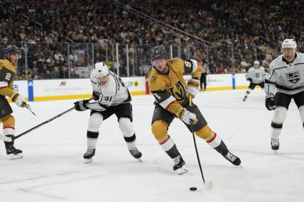 Dec 28, 2023; Las Vegas, Nevada, USA; Vegas Golden Knights center Jack Eichel (9) skates with the puck against Los Angeles Kings right wing Carl Grundstrom (91) during the first period at T-Mobile Arena. Mandatory Credit: Lucas Peltier-USA TODAY Sports