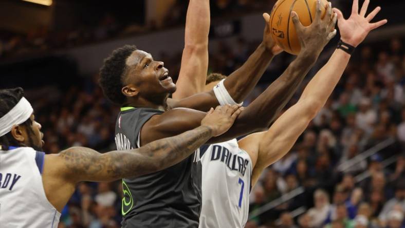 Dec 28, 2023; Minneapolis, Minnesota, USA; Dallas Mavericks guard Jaden Hardy (1) fouls Minnesota Timberwolves guard Anthony Edwards (5) as he goes to the basket in the third quarter at Target Center. Mandatory Credit: Bruce Kluckhohn-USA TODAY Sports