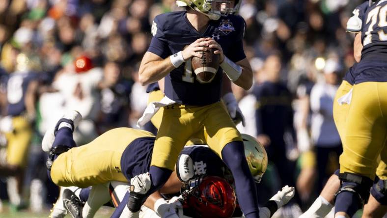 Dec 29, 2023; El Paso, TX, USA; Notre Dame Fighting Irish quarterback Steve Angeli (18) drops back to pass against the Oregon State Beavers defense in the first half at Sun Bowl Stadium. Mandatory Credit: Ivan Pierre Aguirre-USA TODAY Sports