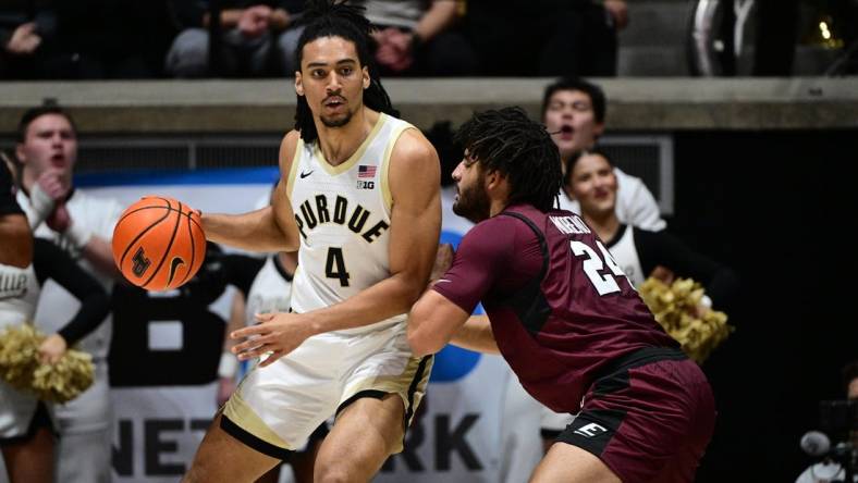 Dec 29, 2023; West Lafayette, Indiana, USA; Purdue Boilermakers forward Trey Kaufman-Renn (4) leans into Eastern Kentucky Colonels forward Michael Moreno (24) during the first half at Mackey Arena. Mandatory Credit: Marc Lebryk-USA TODAY Sports