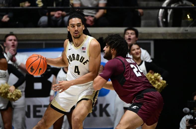 Dec 29, 2023; West Lafayette, Indiana, USA; Purdue Boilermakers forward Trey Kaufman-Renn (4) leans into Eastern Kentucky Colonels forward Michael Moreno (24) during the first half at Mackey Arena. Mandatory Credit: Marc Lebryk-USA TODAY Sports
