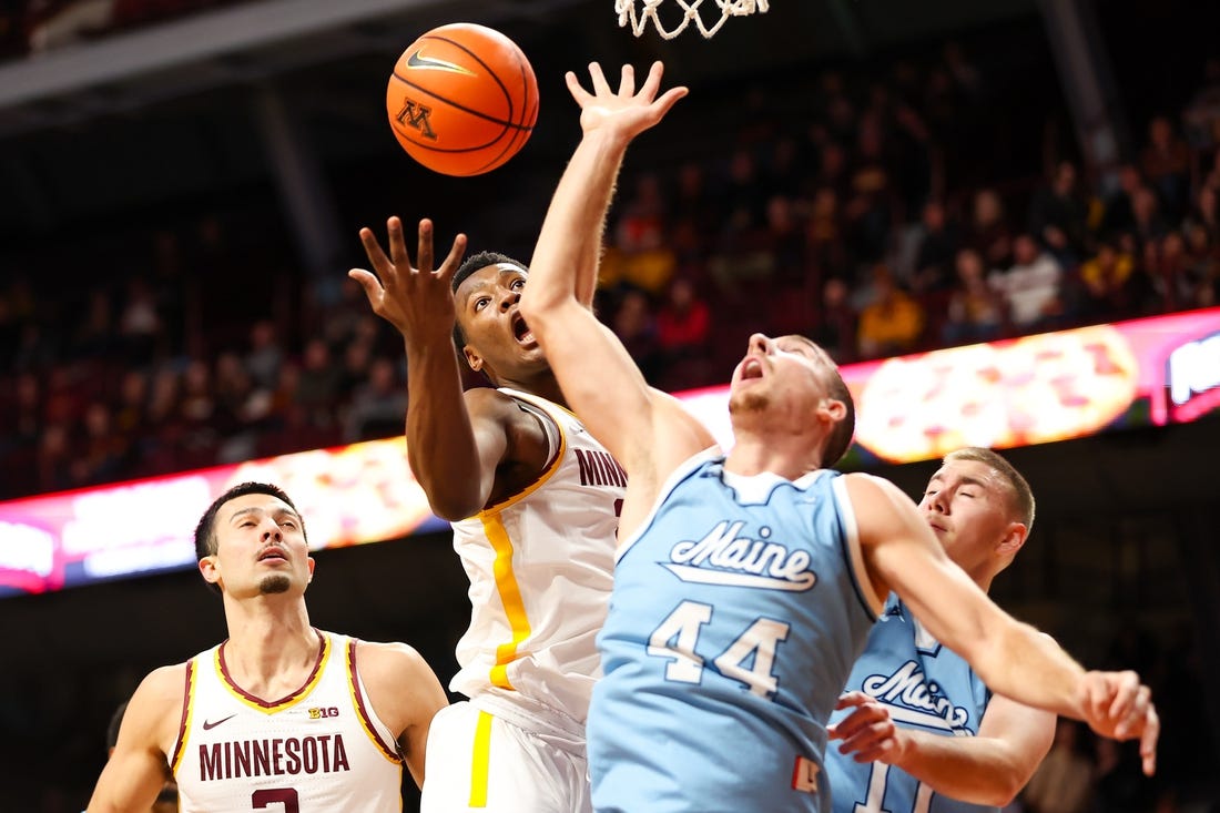 Dec 29, 2023; Minneapolis, Minnesota, USA; Minnesota Golden Gophers forward Pharrel Payne (21) and Maine Black Bears forward Peter Filipovity (44) jump for a rebound during the first half at Williams Arena. Mandatory Credit: Matt Krohn-USA TODAY Sports