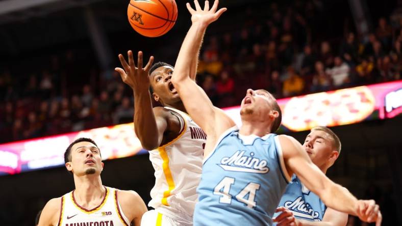 Dec 29, 2023; Minneapolis, Minnesota, USA; Minnesota Golden Gophers forward Pharrel Payne (21) and Maine Black Bears forward Peter Filipovity (44) jump for a rebound during the first half at Williams Arena. Mandatory Credit: Matt Krohn-USA TODAY Sports