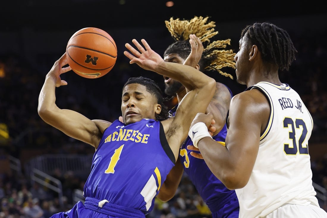 Dec 29, 2023; Ann Arbor, Michigan, USA;  m1 go for the rebound in the first half over Michigan Wolverines forward Tarris Reed Jr. (32) in the first half at Crisler Center. Mandatory Credit: Rick Osentoski-USA TODAY Sports