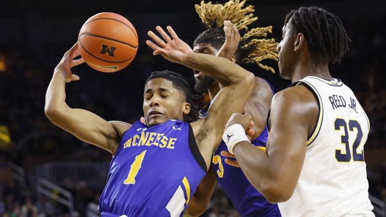 Dec 29, 2023; Ann Arbor, Michigan, USA;  m1 go for the rebound in the first half over Michigan Wolverines forward Tarris Reed Jr. (32) in the first half at Crisler Center. Mandatory Credit: Rick Osentoski-USA TODAY Sports