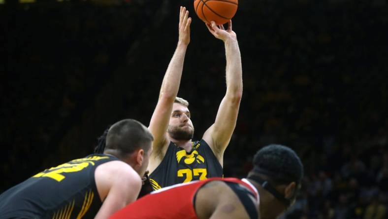 Iowa's Ben Krikke (23) attempts a free throw against Northern Illinois Friday, Dec. 29, 2023 at Carver-Hawkeye Arena in Iowa City, Iowa.