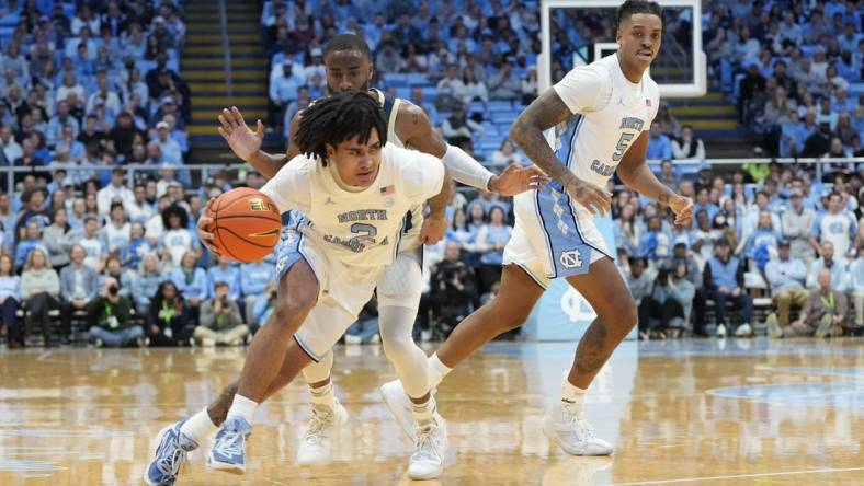 Dec 29, 2023; Chapel Hill, North Carolina, USA; North Carolina Tar Heels guard Elliot Cadeau (2) dribbles in the first half at Dean E. Smith Center. Mandatory Credit: Bob Donnan-USA TODAY Sports