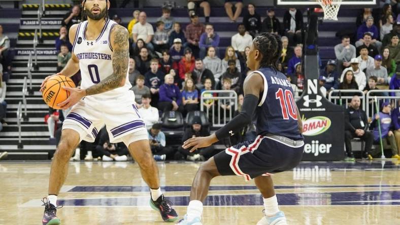 Dec 29, 2023; Evanston, Illinois, USA; Jackson State Tigers guard Chase Adams (10) defends Northwestern Wildcats guard Boo Buie (0) during the first half at Welsh-Ryan Arena. Mandatory Credit: David Banks-USA TODAY Sports