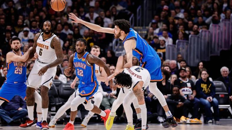 Dec 29, 2023; Denver, Colorado, USA; Oklahoma City Thunder forward Chet Holmgren (7) and Denver Nuggets guard Julian Strawther (3) battle for the ball in the second quarter at Ball Arena. Mandatory Credit: Isaiah J. Downing-USA TODAY Sports