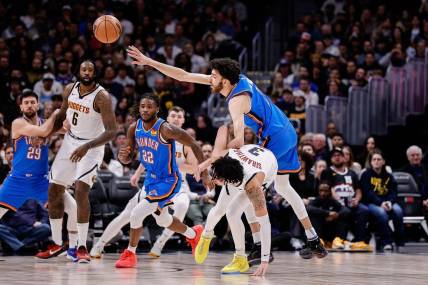 Dec 29, 2023; Denver, Colorado, USA; Oklahoma City Thunder forward Chet Holmgren (7) and Denver Nuggets guard Julian Strawther (3) battle for the ball in the second quarter at Ball Arena. Mandatory Credit: Isaiah J. Downing-USA TODAY Sports