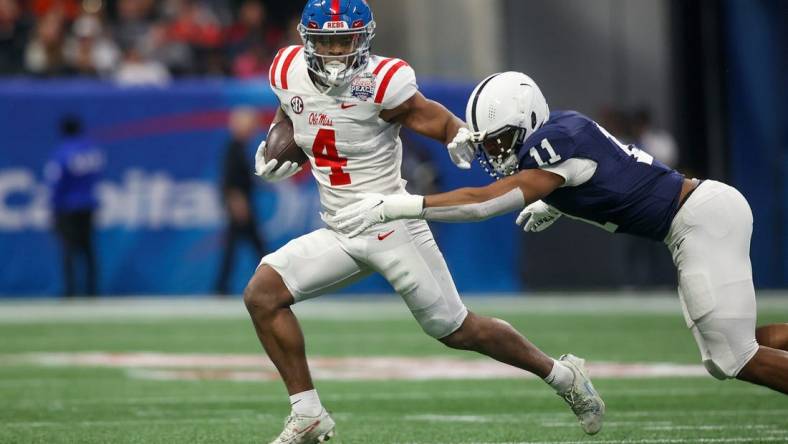 Dec 30, 2023; Atlanta, GA, USA; Mississippi Rebels running back Quinshon Judkins (4) is tackled by Penn State Nittany Lions linebacker Abdul Carter (11) in the first quarter at Mercedes-Benz Stadium. Mandatory Credit: Brett Davis-USA TODAY Sports