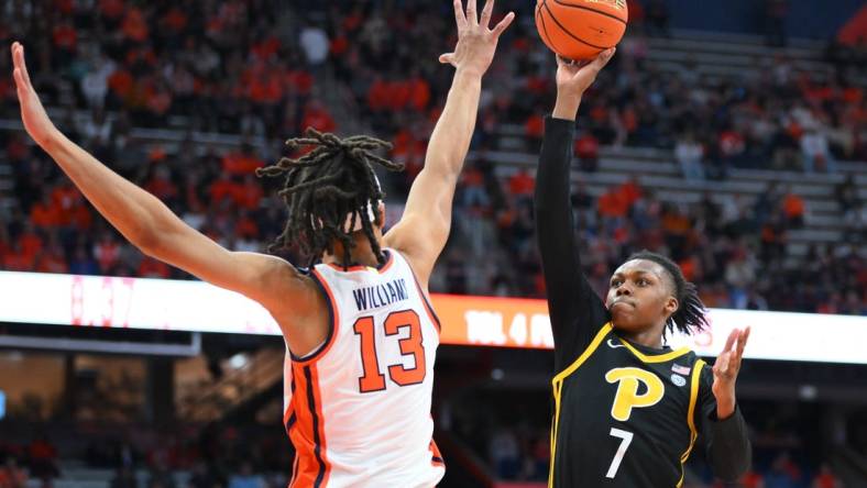 Dec 30, 2023; Syracuse, New York, USA; Pittsburgh Panthers guard Carlton Carrington (7) shoots as Syracuse Orange forward Benny Williams (13) defends during the first half at the JMA Wireless Dome. Mandatory Credit: Rich Barnes-USA TODAY Sports