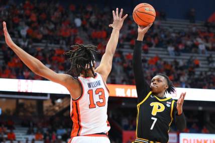 Dec 30, 2023; Syracuse, New York, USA; Pittsburgh Panthers guard Carlton Carrington (7) shoots as Syracuse Orange forward Benny Williams (13) defends during the first half at the JMA Wireless Dome. Mandatory Credit: Rich Barnes-USA TODAY Sports