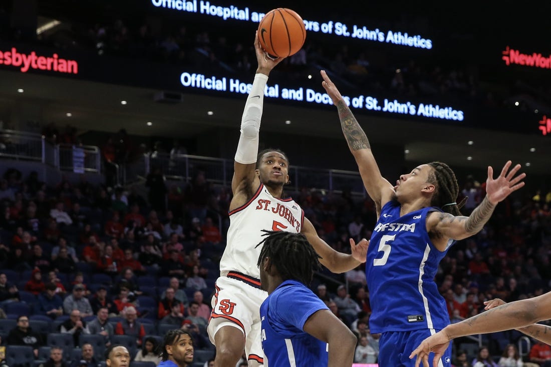 Dec 30, 2023; Elmont, New York, USA;  St. John's Red Storm guard Daniss Jenkins (5) shoots past Hofstra Pride guard Jaquan Carlos (5) in the second half at UBS Arena. Mandatory Credit: Wendell Cruz-USA TODAY Sports