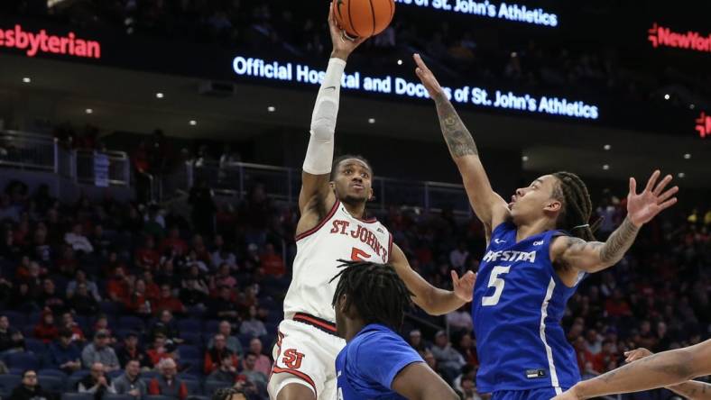 Dec 30, 2023; Elmont, New York, USA;  St. John's Red Storm guard Daniss Jenkins (5) shoots past Hofstra Pride guard Jaquan Carlos (5) in the second half at UBS Arena. Mandatory Credit: Wendell Cruz-USA TODAY Sports