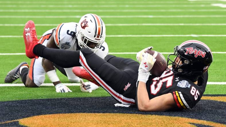 Dec 30, 2023; Nashville, TN, USA; Maryland Terrapins tight end Preston Howard (85) catches a touchdown pass against Auburn Tigers linebacker Eugene Asante (9) during the first half at Nissan Stadium. Mandatory Credit: Christopher Hanewinckel-USA TODAY Sports