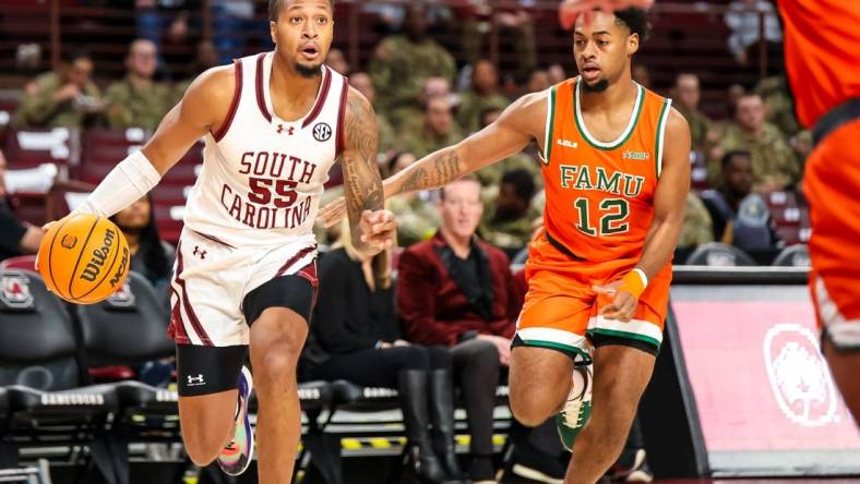 Dec 30, 2023; Columbia, South Carolina, USA; South Carolina Gamecocks guard Ta'Lon Cooper (55) drives around Florida A&M Rattlers guard K'Jei Parker (12) in the first quarter at Colonial Life Arena. Mandatory Credit: Jeff Blake-USA TODAY Sports