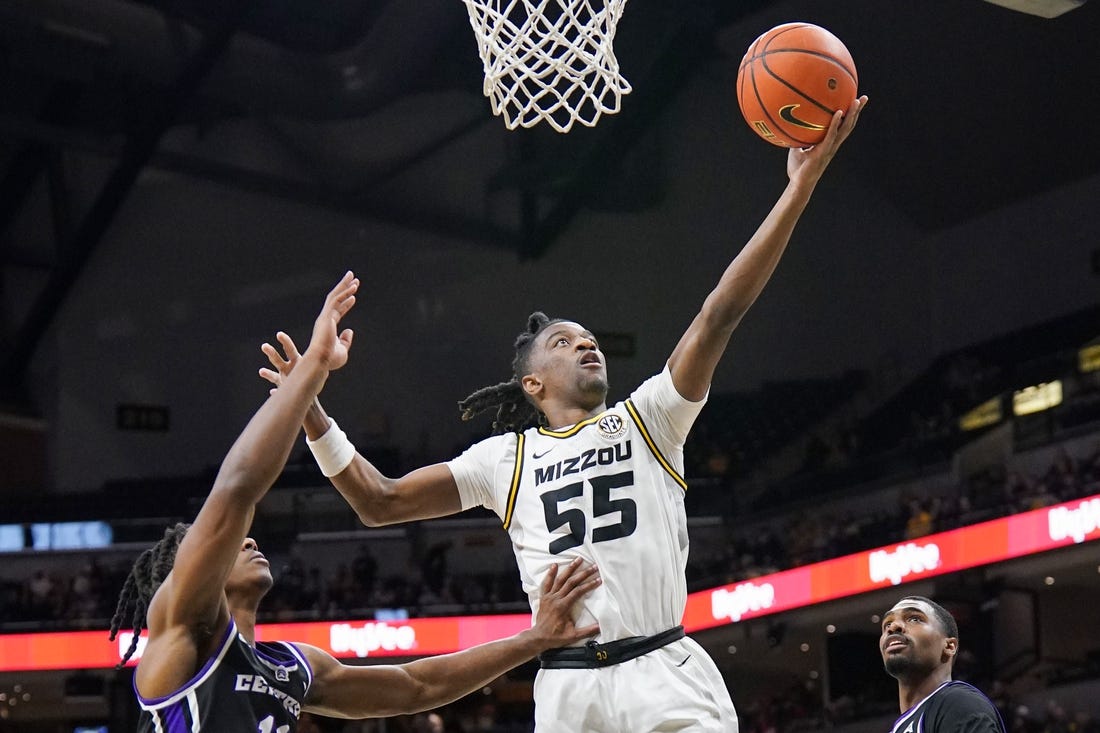 Dec 30, 2023; Columbia, Missouri, USA; Missouri Tigers guard Sean East II (55) scores as Central Arkansas Bears guard Carl Daughtery Jr. (11) defends during the first half  at Mizzou Arena. Mandatory Credit: Denny Medley-USA TODAY Sports