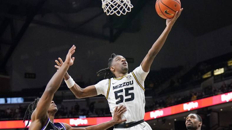 Dec 30, 2023; Columbia, Missouri, USA; Missouri Tigers guard Sean East II (55) scores as Central Arkansas Bears guard Carl Daughtery Jr. (11) defends during the first half  at Mizzou Arena. Mandatory Credit: Denny Medley-USA TODAY Sports