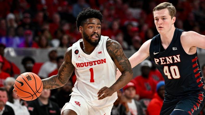 Dec 30, 2023; Houston, Texas, USA;  Houston Cougars guard Jamal Shead (1) controls the ball as Pennsylvania Quakers guard George Smith (40) defends during the first half at Fertitta Center. Mandatory Credit: Maria Lysaker-USA TODAY Sports