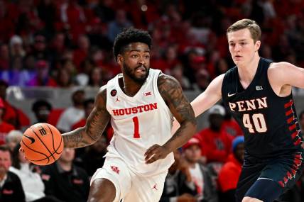 Dec 30, 2023; Houston, Texas, USA;  Houston Cougars guard Jamal Shead (1) controls the ball as Pennsylvania Quakers guard George Smith (40) defends during the first half at Fertitta Center. Mandatory Credit: Maria Lysaker-USA TODAY Sports