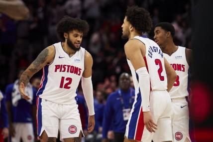 Dec 30, 2023; Detroit, Michigan, USA;  Detroit Pistons forward Isaiah Livers (12) and guard Cade Cunningham (2) celebrate after the game against the Toronto Raptors at Little Caesars Arena. Mandatory Credit: Rick Osentoski-USA TODAY Sports