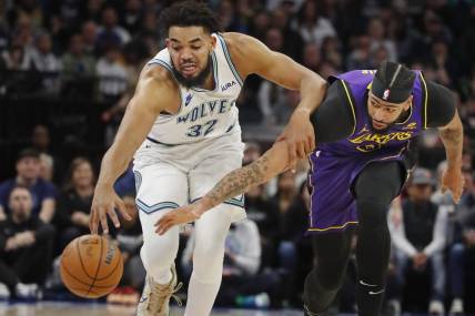 Dec 30, 2023; Minneapolis, Minnesota, USA; Los Angeles Lakers forward Anthony Davis (3) knocks the ball away from Minnesota Timberwolves forward Karl-Anthony Towns (32) in the first quarter at Target Center. Mandatory Credit: Bruce Kluckhohn-USA TODAY Sports