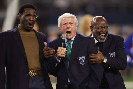 Dec 30, 2023; Arlington, Texas, USA; (L to R) Former Dallas Cowboys Michael Irvin, Jimmy Johnson and Emmitt Smith react during the Ring of Honor ceremony at the half time of the game against the Detroit Lions at AT&T Stadium. Mandatory Credit: Tim Heitman-USA TODAY Sports