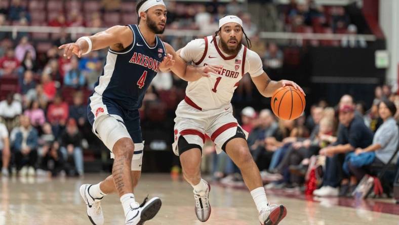 Dec 31, 2023; Stanford, California, USA; Stanford Cardinal guard Jared Bynum (1) drives the ball against Arizona Wildcats guard Kylan Boswell (4) during the first half at Maples Pavilion. Mandatory Credit: Stan Szeto-USA TODAY Sports