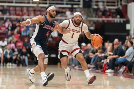 Dec 31, 2023; Stanford, California, USA; Stanford Cardinal guard Jared Bynum (1) drives the ball against Arizona Wildcats guard Kylan Boswell (4) during the first half at Maples Pavilion. Mandatory Credit: Stan Szeto-USA TODAY Sports