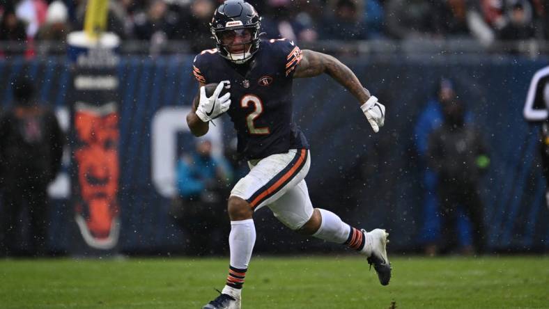 Dec 31, 2023; Chicago, Illinois, USA;  Chicago Bears wide receiver DJ Moore (2) runs with the ball after a catch in the second half against the Atlanta Falcons at Soldier Field. Mandatory Credit: Jamie Sabau-USA TODAY Sports