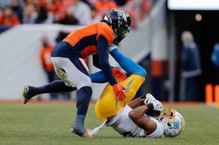 Dec 31, 2023; Denver, Colorado, USA; Denver Broncos safety P.J. Locke (6) gets caught up with Los Angeles Chargers wide receiver Keelan Doss (86) in the second quarter at Empower Field at Mile High. Mandatory Credit: Isaiah J. Downing-USA TODAY Sports