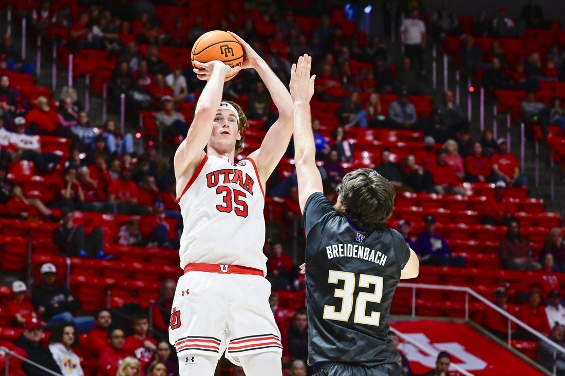 Dec 31, 2023; Salt Lake City, Utah, USA; Utah Utes center Branden Carlson (35) takes a shot over Washington Huskies forward Wilhelm Breidenbach (32) during the first half at the the Jon M. Huntsman Center. Mandatory Credit: Christopher Creveling-USA TODAY Sports