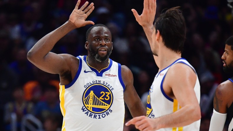 Draymond Green: Warriors Draymond Green high fives with teammate Dario Saric