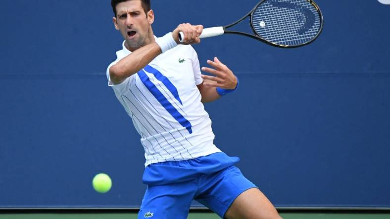 Sep 6, 2020; Flushing Meadows, New York, USA; Novak Djokovic of Serbia hits a forehand against Pablo Carreno Busta of Spain (not pictured) on day seven of the 2020 U.S. Open tennis tournament at USTA Billie Jean King National Tennis Center. Mandatory Credit: Danielle Parhizkaran-USA TODAY Sports