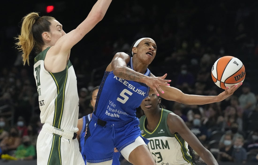 Aug 12, 2021; Phoenix, Arizona, USA; Connecticut Sun guard Jasmine Thomas (5) drives against Seattle Storm forward Breanna Stewart (30) in the second half during the Inaugural WNBA Commissioners Cup Championship Game at Footprint Center. Mandatory Credit: Rick Scuteri-USA TODAY Sports