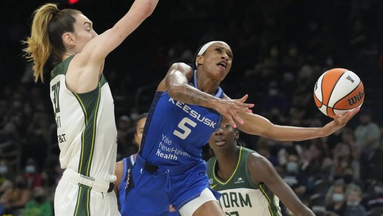 Aug 12, 2021; Phoenix, Arizona, USA; Connecticut Sun guard Jasmine Thomas (5) drives against Seattle Storm forward Breanna Stewart (30) in the second half during the Inaugural WNBA Commissioners Cup Championship Game at Footprint Center. Mandatory Credit: Rick Scuteri-USA TODAY Sports