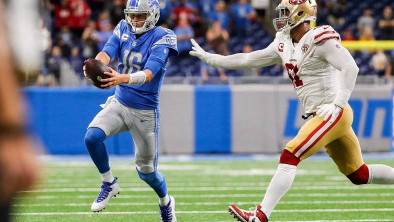 Detroit Lions quarterback Jared Goff (16) runs out of bounds against San Francisco 49ers defensive end Arik Armstead (91) during the second half at Ford Field in Detroit on Sunday, Sept. 12, 2021.