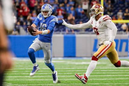 Detroit Lions quarterback Jared Goff (16) runs out of bounds against San Francisco 49ers defensive end Arik Armstead (91) during the second half at Ford Field in Detroit on Sunday, Sept. 12, 2021.