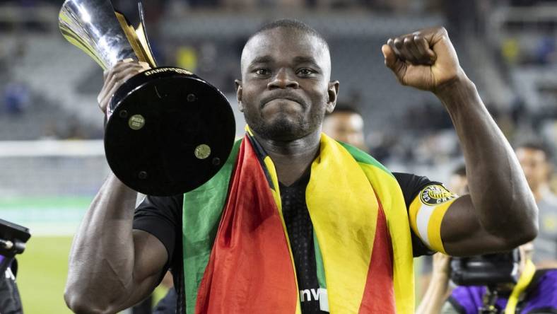 Sep 29, 2021; Columbus, OH, USA; Columbus Crew defender Jonathan Mensah (4) displays the trophy for supporters after defeating Cruz Azul to win the 2021 Campeones Cup match at Lower.com Field Mandatory Credit: Greg Bartram-USA TODAY Sports