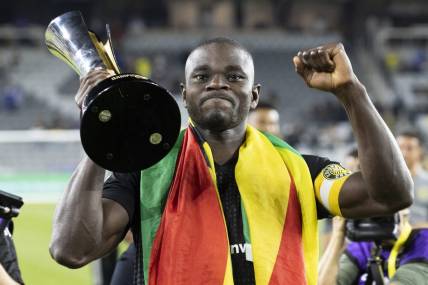 Sep 29, 2021; Columbus, OH, USA; Columbus Crew defender Jonathan Mensah (4) displays the trophy for supporters after defeating Cruz Azul to win the 2021 Campeones Cup match at Lower.com Field Mandatory Credit: Greg Bartram-USA TODAY Sports