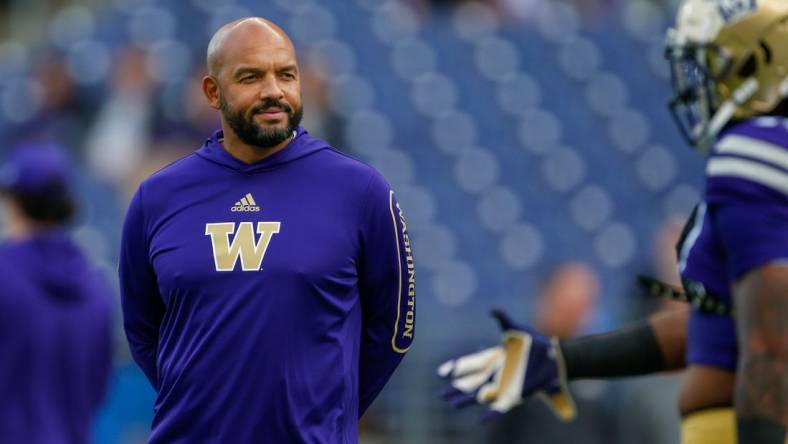 Oct 16, 2021; Seattle, Washington, USA; Washington Huskies head coach Jimmy Lake watches pregame warmups against the UCLA Bruins at Alaska Airlines Field at Husky Stadium. Mandatory Credit: Joe Nicholson-USA TODAY Sports