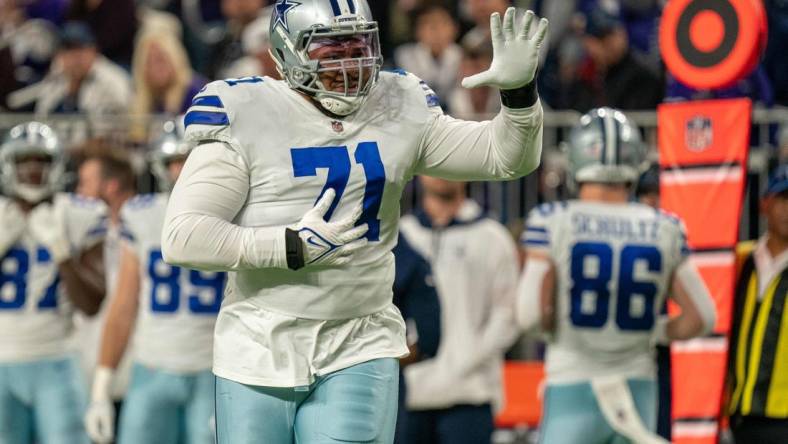 Oct 31, 2021; Minneapolis, Minnesota, USA; Dallas Cowboys offensive tackle La'el Collins (71) indicates he is an eligible receiver entering the game in the third quarter against the Minnesota Vikings at U.S. Bank Stadium. Mandatory Credit: Matt Blewett-USA TODAY Sports