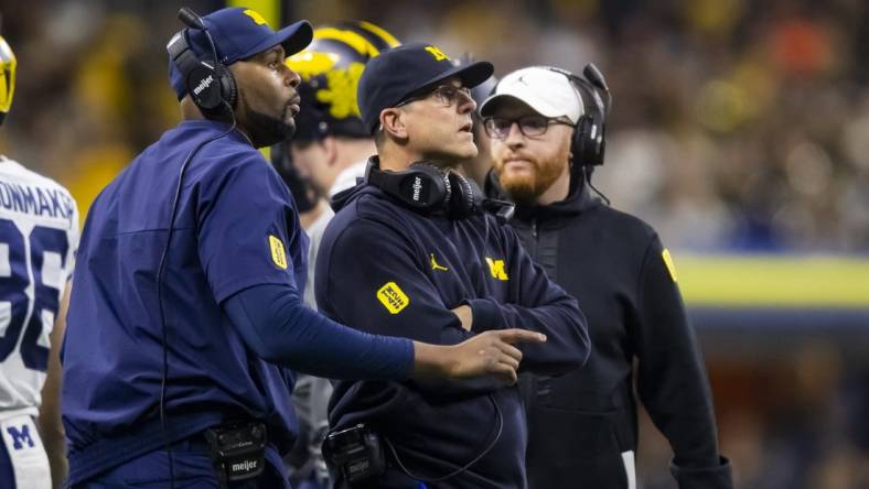 Dec 4, 2021; Indianapolis, IN, USA; Michigan Wolverines offensive line coach Sherrone Moore (left), head coach Jim Harbaugh (center) and special teams coordinator Jay Harbaugh against the Iowa Hawkeyes in the Big Ten Conference championship game at Lucas Oil Stadium. Mandatory Credit: Mark J. Rebilas-USA TODAY Sports