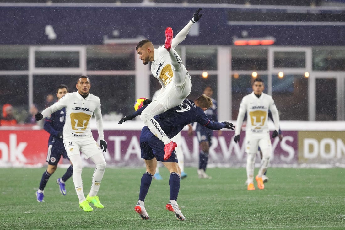 Mar 9, 2022; Foxborough, Massachusetts, USA; Pumas UNAM defender Nicolas Freire (23) heads the ball over New England Revolution forward Adam Buksa (9) during the second half at Gillette Stadium during the 2022 CONCACAF Champions League Quarterfinals. Mandatory Credit: Paul Rutherford-USA TODAY Sports
