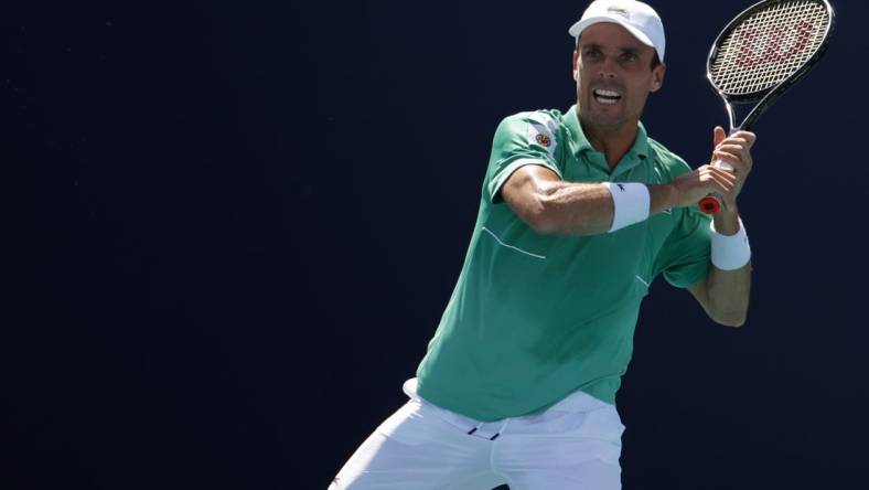 Mar 28, 2022; Miami Gardens, FL, USA; Roberto Bautista Agut (ESP) hits a forehand against Jenson Brooksby (USA)(not pictured) in a third round men's singles match in the Miami Open at Hard Rock Stadium. Mandatory Credit: Geoff Burke-USA TODAY Sports