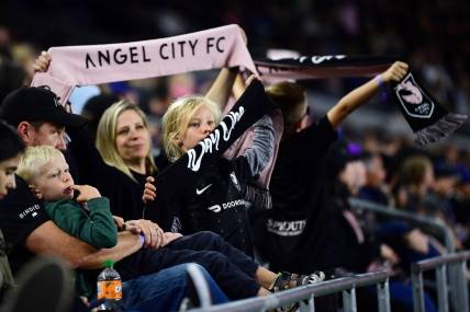Apr 29, 2022; Los Angeles, California, USA; Young Angel City FC fans show their support during the second half of the game against the North Carolina Courage at Banc of California Stadium. Angel City FC won 2-1. Mandatory Credit: Gary A. Vasquez-USA TODAY Sports
