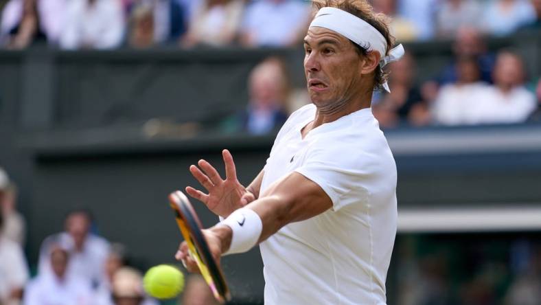 Jul 6, 2022; London, England, United Kingdom; 
Rafael Nadal (ESP) returns a shot during his quarter finals men s singles match against Taylor Fritz (USA) on Centre court at All England Lawn Tennis and Croquet Club. Mandatory Credit: Peter van den Berg-USA TODAY Sports