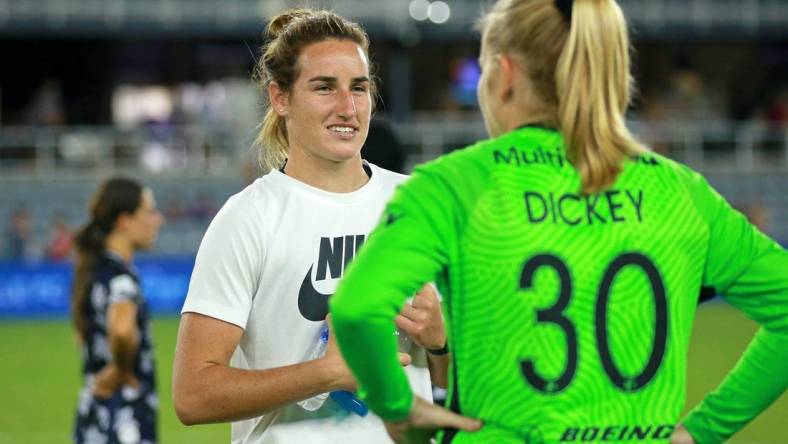 Aug 2, 2022; Louisville, Kentucky, USA; Racing Louisville FC goalkeeper Hillary Beall (left) talks with OL Reign goalkeeper Claudia Dickey (30) after the game at Lynn Family Stadium. Mandatory Credit: EM Dash-USA TODAY Sports