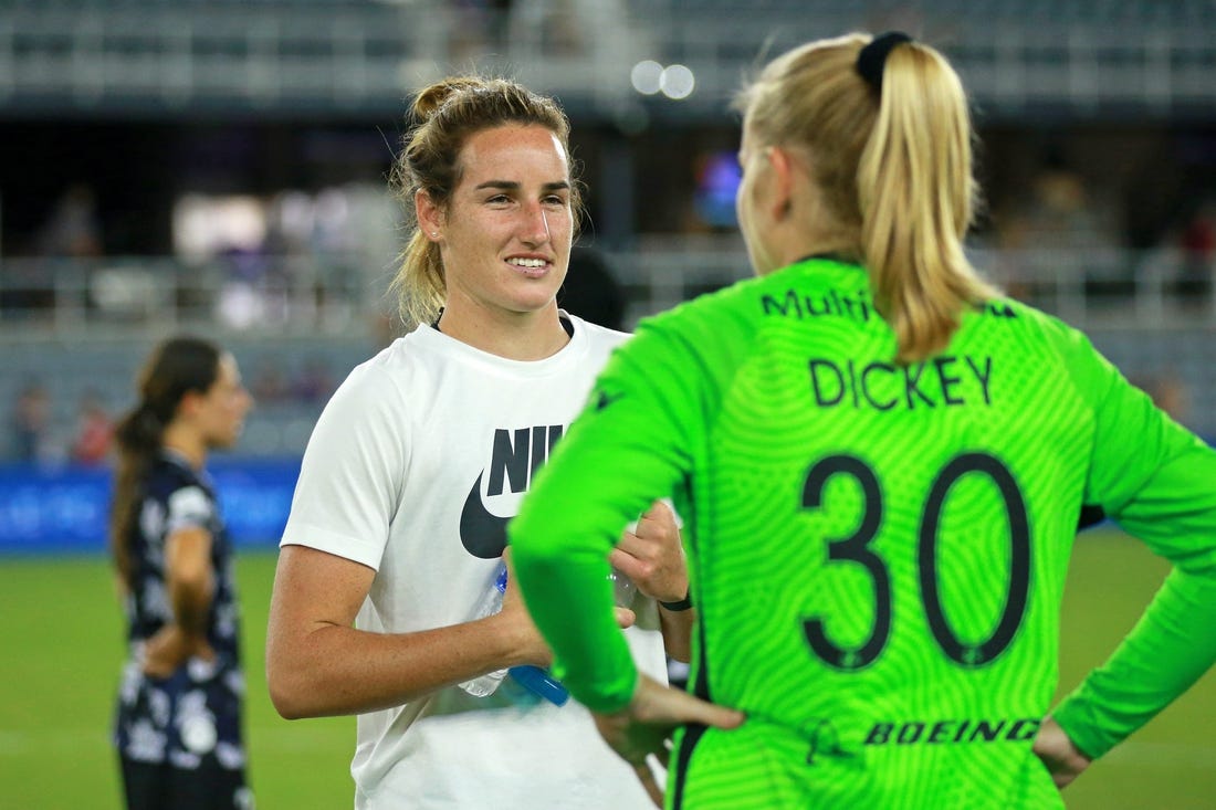 Aug 2, 2022; Louisville, Kentucky, USA; Racing Louisville FC goalkeeper Hillary Beall (left) talks with OL Reign goalkeeper Claudia Dickey (30) after the game at Lynn Family Stadium. Mandatory Credit: EM Dash-USA TODAY Sports